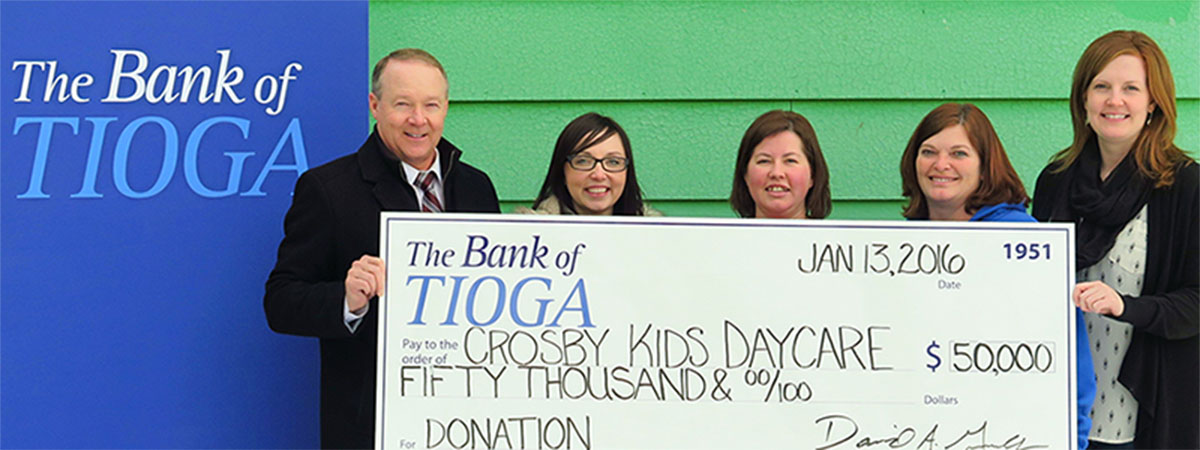 employees and recipients holding a large check