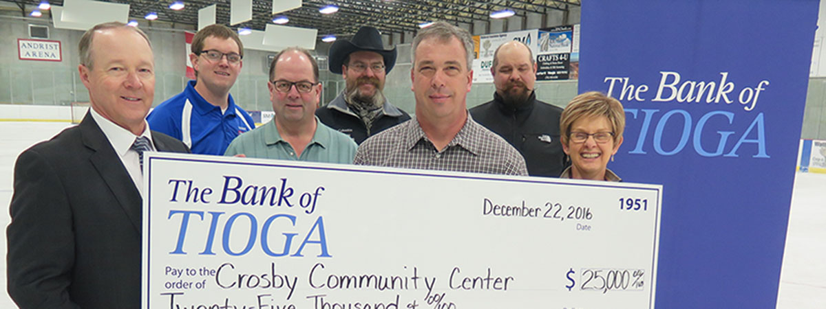 employees and recipients holding a large check