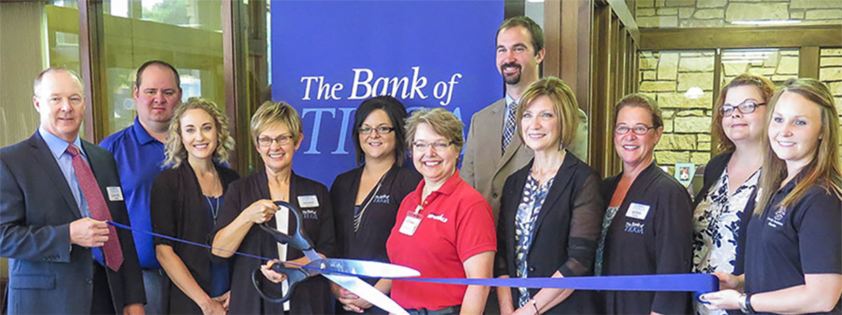 employees cutting the blue ribbon