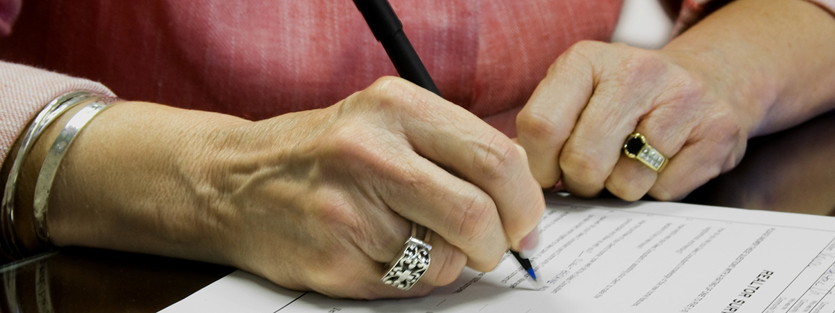 a lady signing financial legal documents