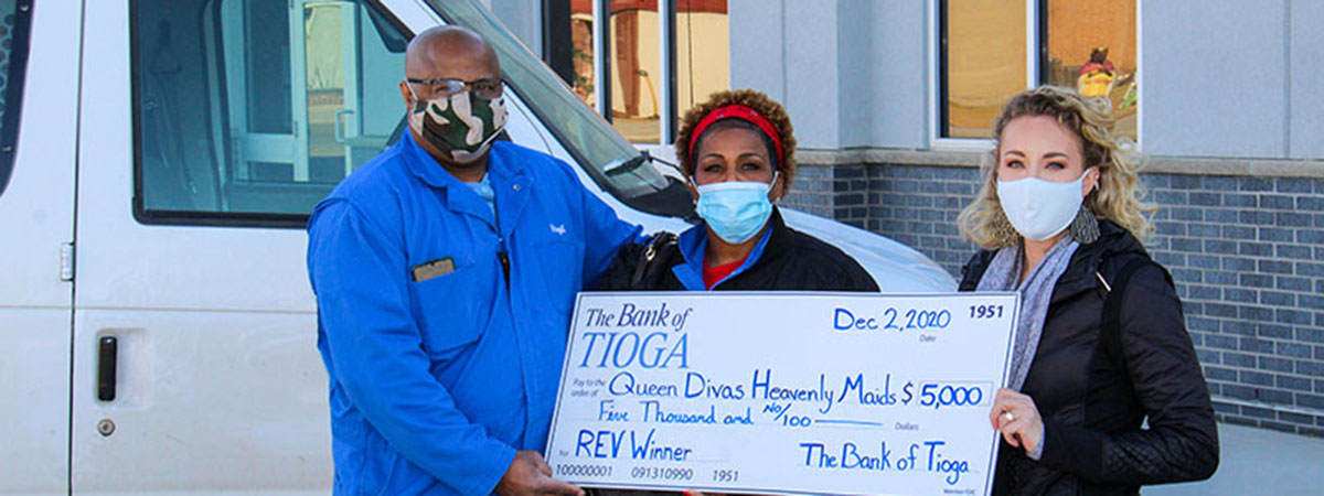 employee and recipients hold large check
