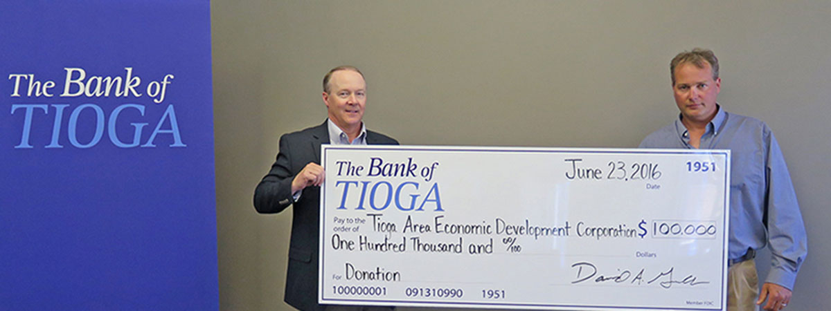 employee and recipient holding large check