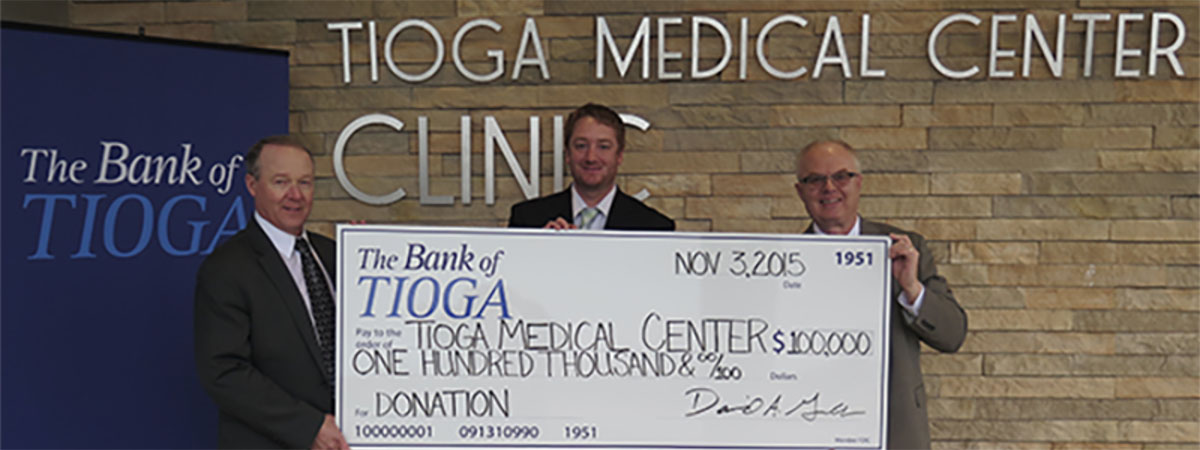 employees and recipients holding a large check